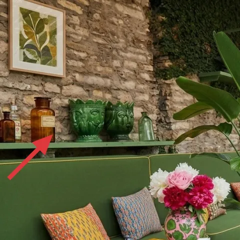 glass bottles and olive-brown bottles on the wall shelf