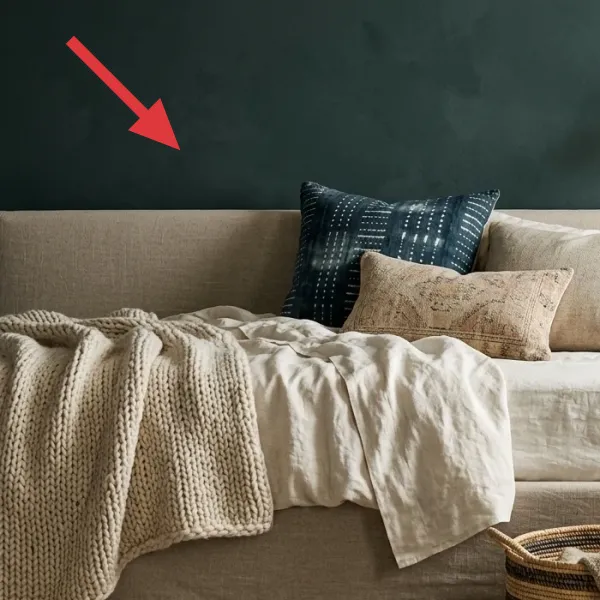 Textured deep teal-green accent wall, showing subtle variations in color and finish behind the bed.