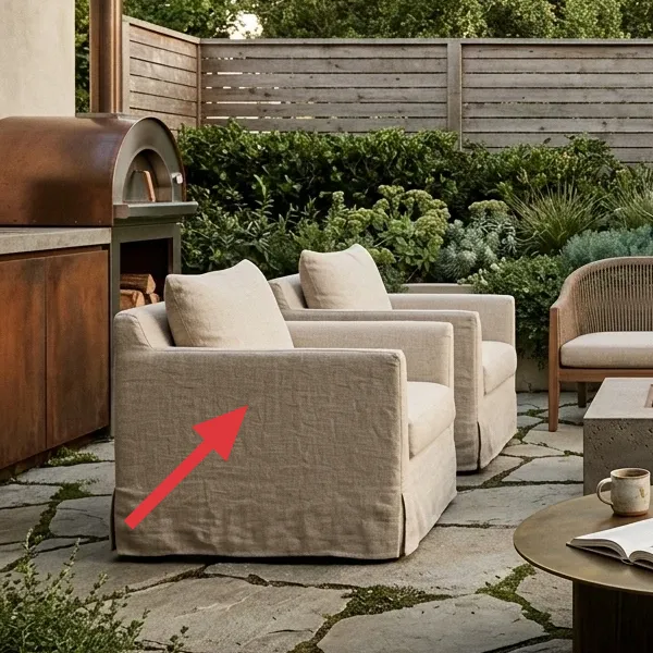 Two linen-covered armchairs on a flagstone patio, representing portable outdoor seating.