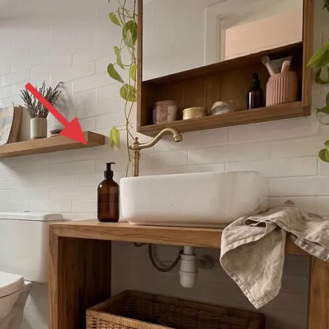 Wood bathroom wall shelf with bottles