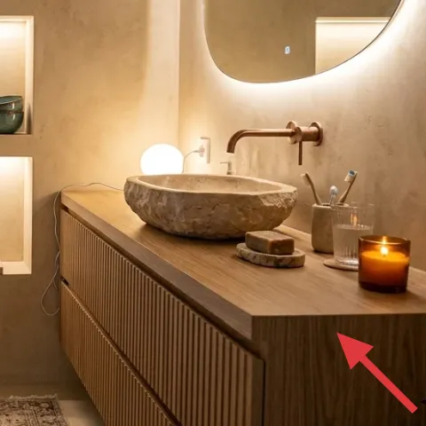 candle in glass on countertop