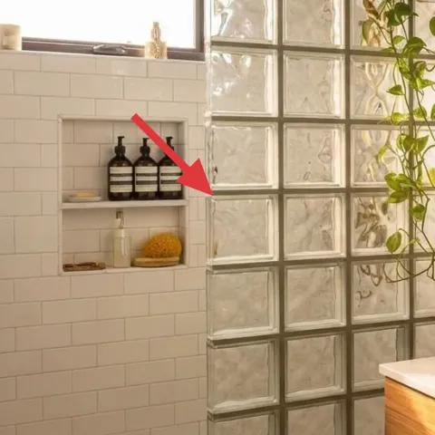 Glass bottles on niche shelf